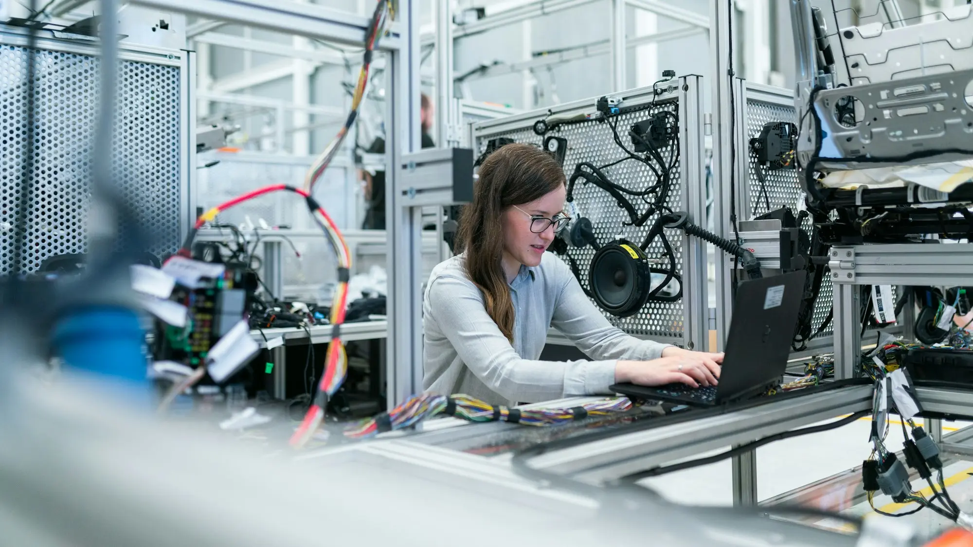 A person working at an instrumented laboratory bench.